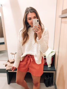 Perfect spring outfit. White knit sweater and coral paperbag waist shorts