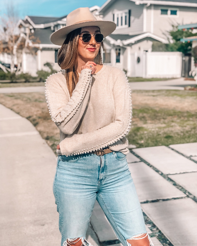 Tan wide brim hat and neutral outfit